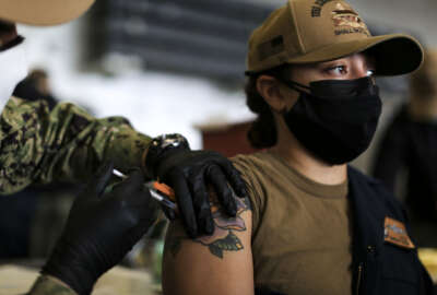 SAN DIEGO (Dec. 28, 2021) Machinist’s Mate (Nuclear) 1st Class Kayla Matos, from Brooklyn, N.Y., receives a COVID-19 booster shot in the hangar bay aboard the aircraft carrier USS Abraham Lincoln (CVN 72). Though not mandatory, the Navy recommends all Navy personnel receive the COVID-19 vaccine booster. (U.S. Navy photo by Mass Communication Specialist 3rd Class Lake Fultz) 211228-N-DN347-1008