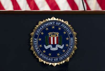 FILE - In this June 14, 2018, file photo, the FBI seal is seen before a news conference at FBI headquarters in Washington. The U.S. government on Tuesday, Jan. 5, 2021, said a devastating hack of federal agencies is “likely Russian in origin” and said the operation appeared to be an “intelligence gathering” effort. The assessment was disclosed in a rare public statement from the FBI and other investigative agencies. (AP Photo/Jose Luis Magana, File)